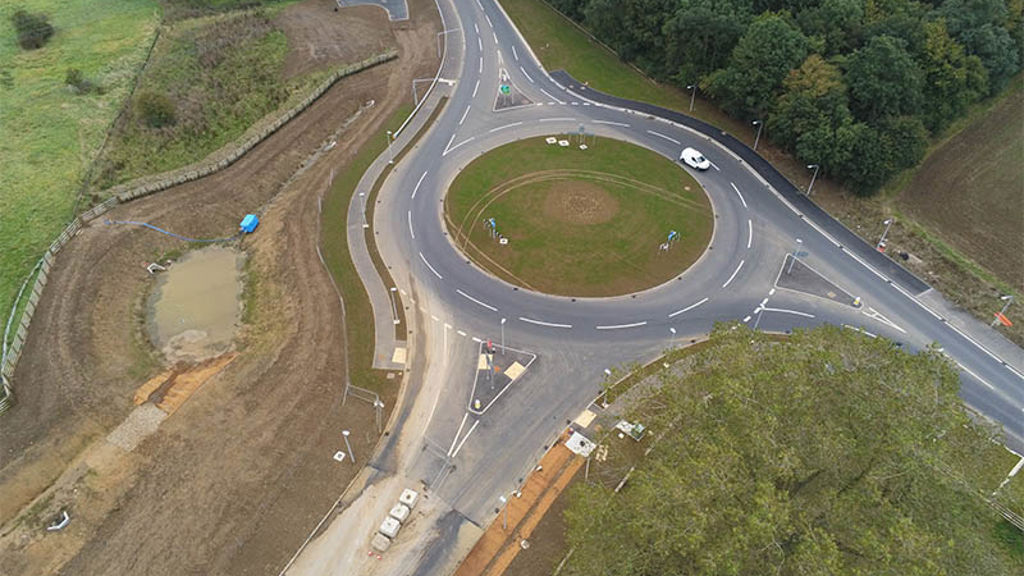 A roundabout with a road and trees.