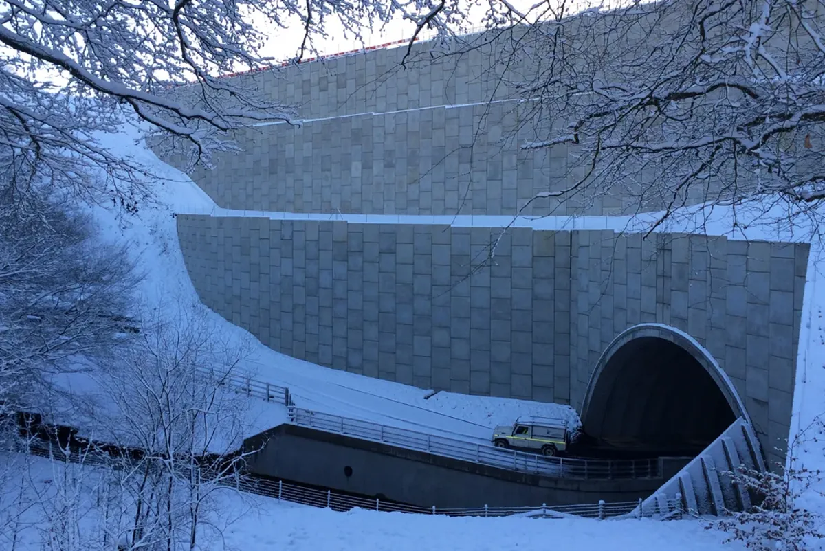 A large white building with a tunnel.