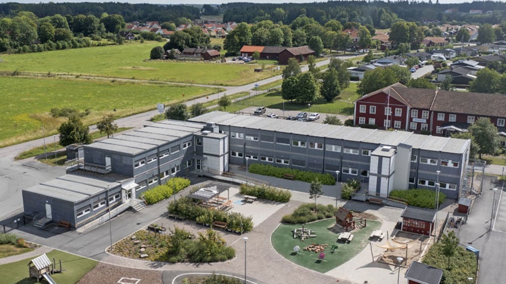 A large building with a parking lot.