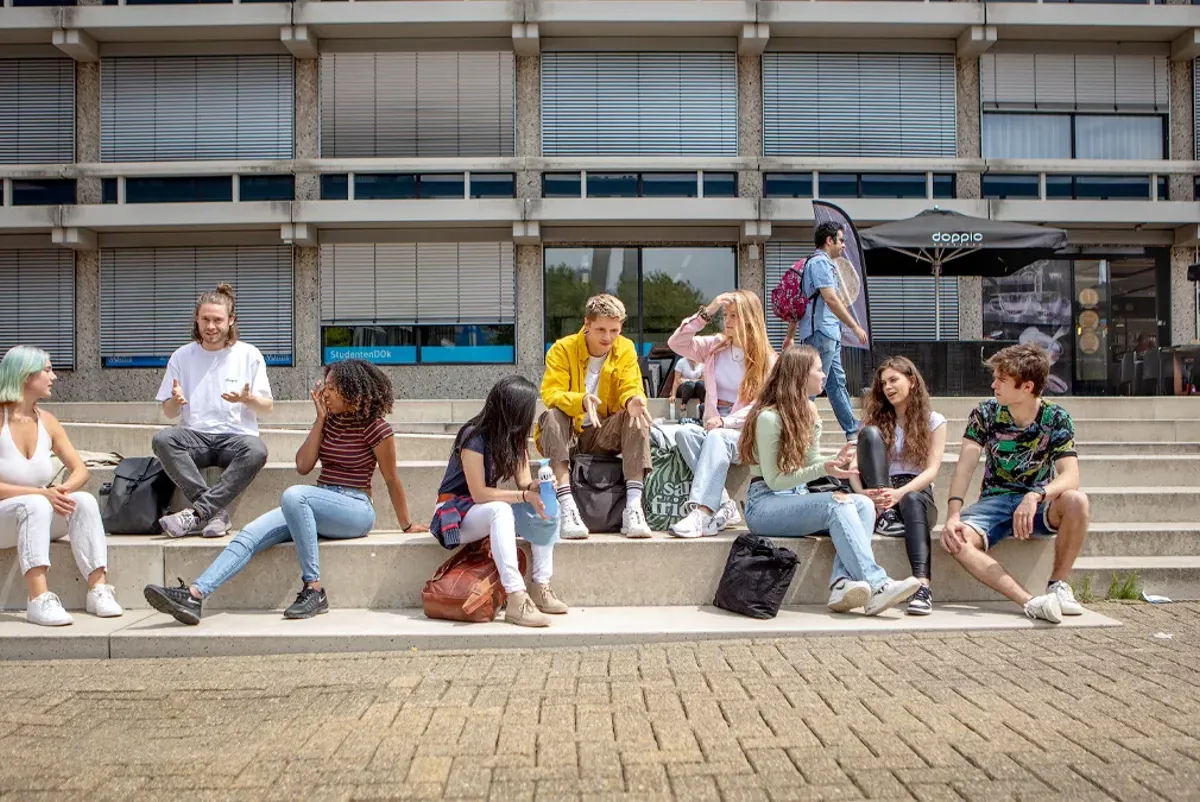 A group of people sitting on steps.