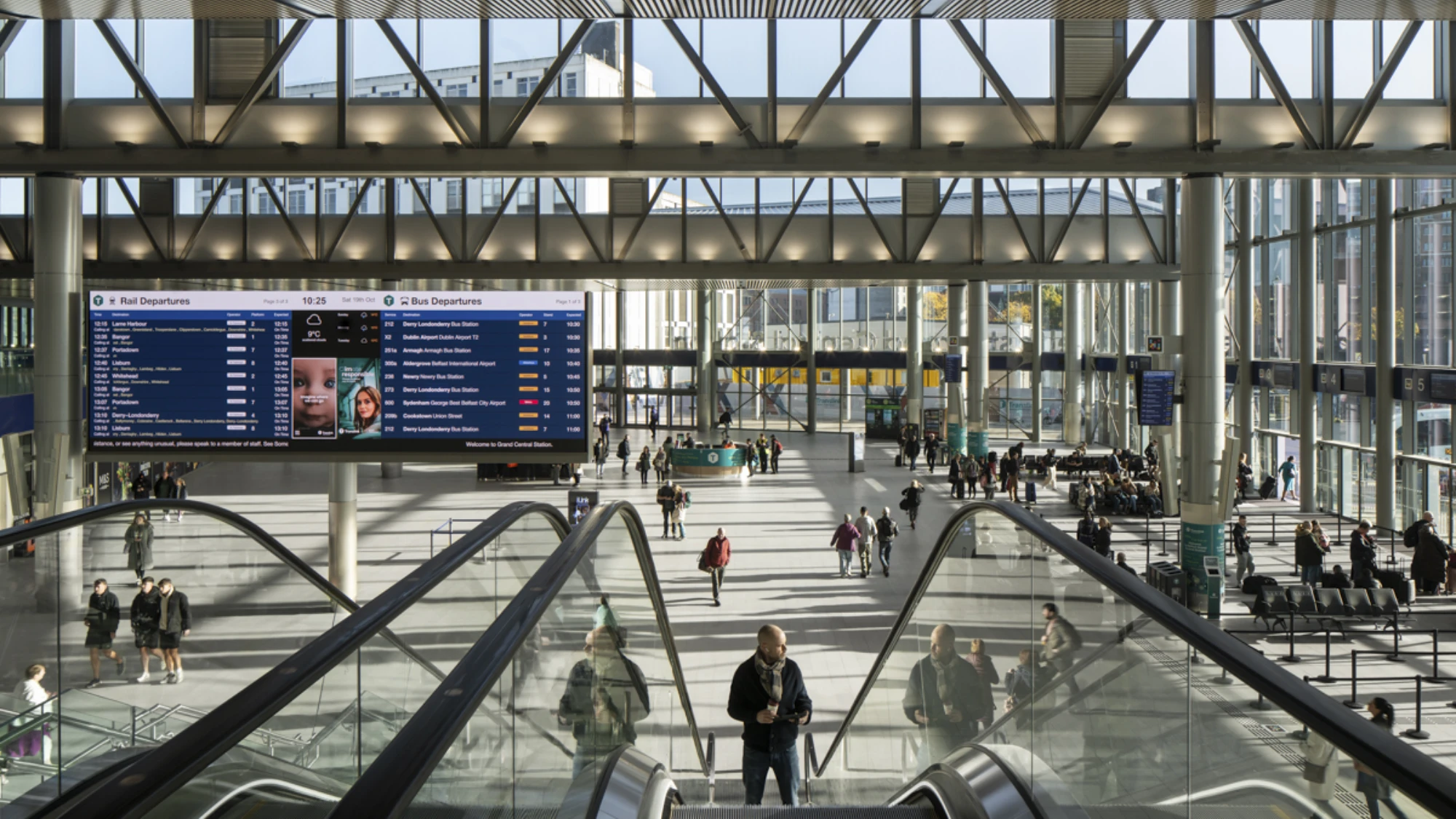 Inside view of Belfast grand central station with escalators and message boards