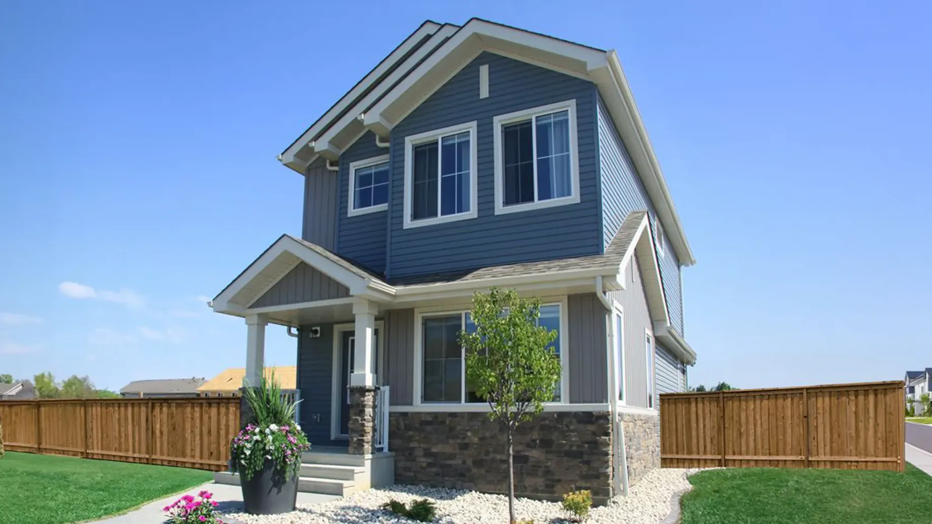 A house with a fence and trees.