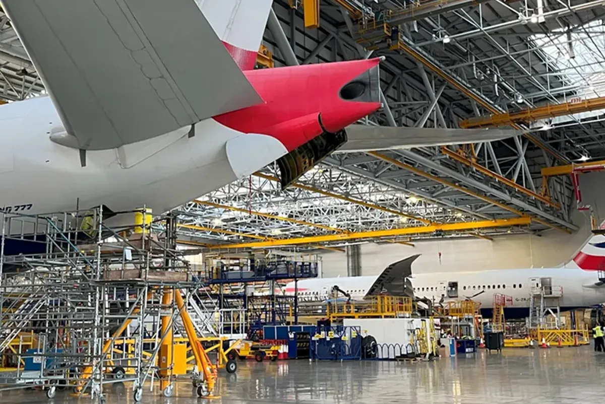 A large airplane in a warehouse.