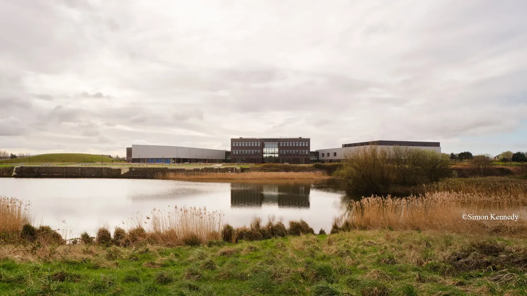 A body of water with buildings in the background.