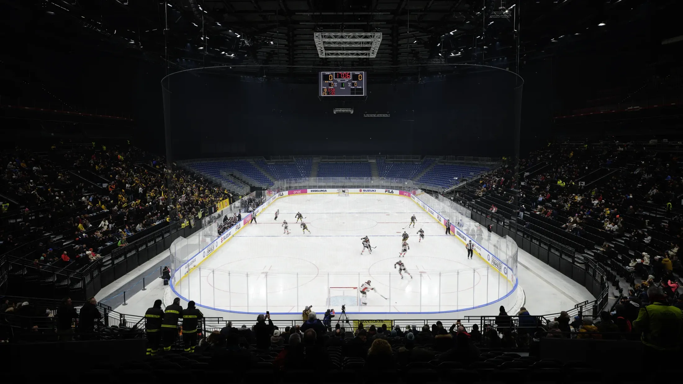 A hockey arena with a crowd watching.
