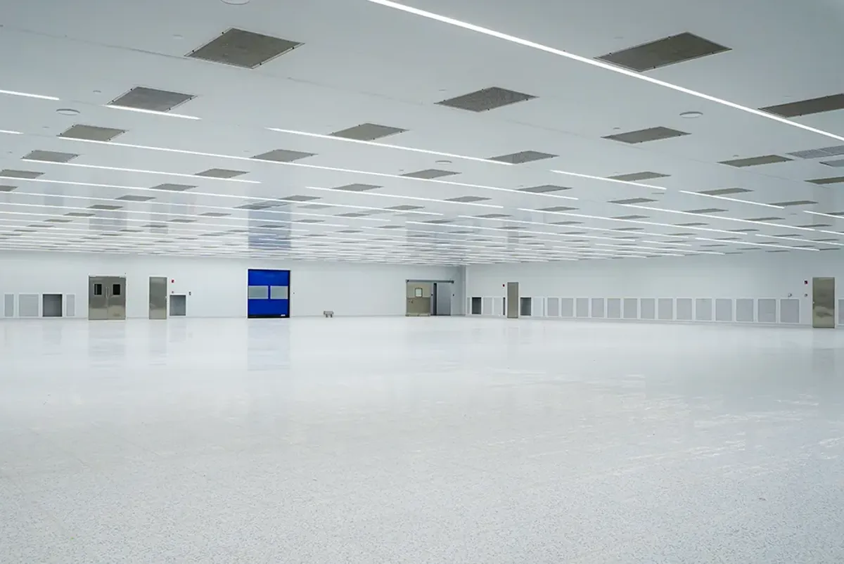 A room with white walls and a blue sign on the ceiling.