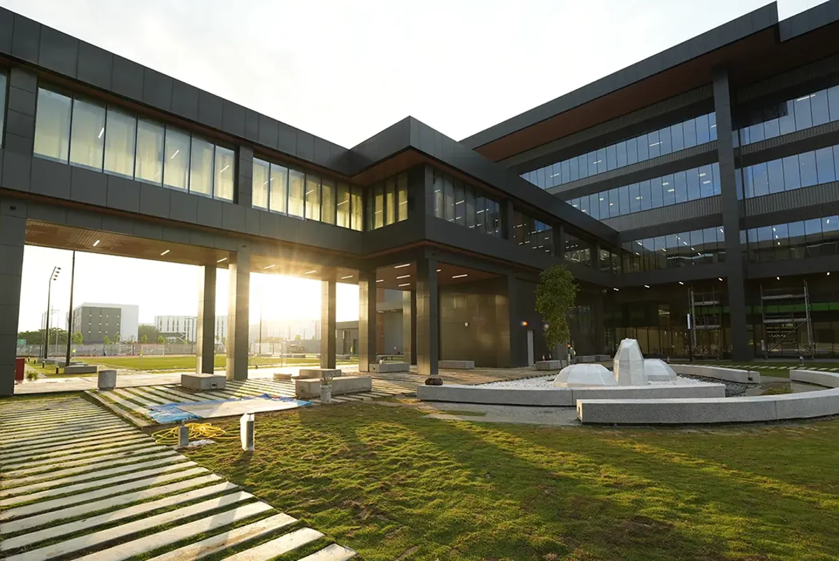 A building with a courtyard and a fountain in front of it.