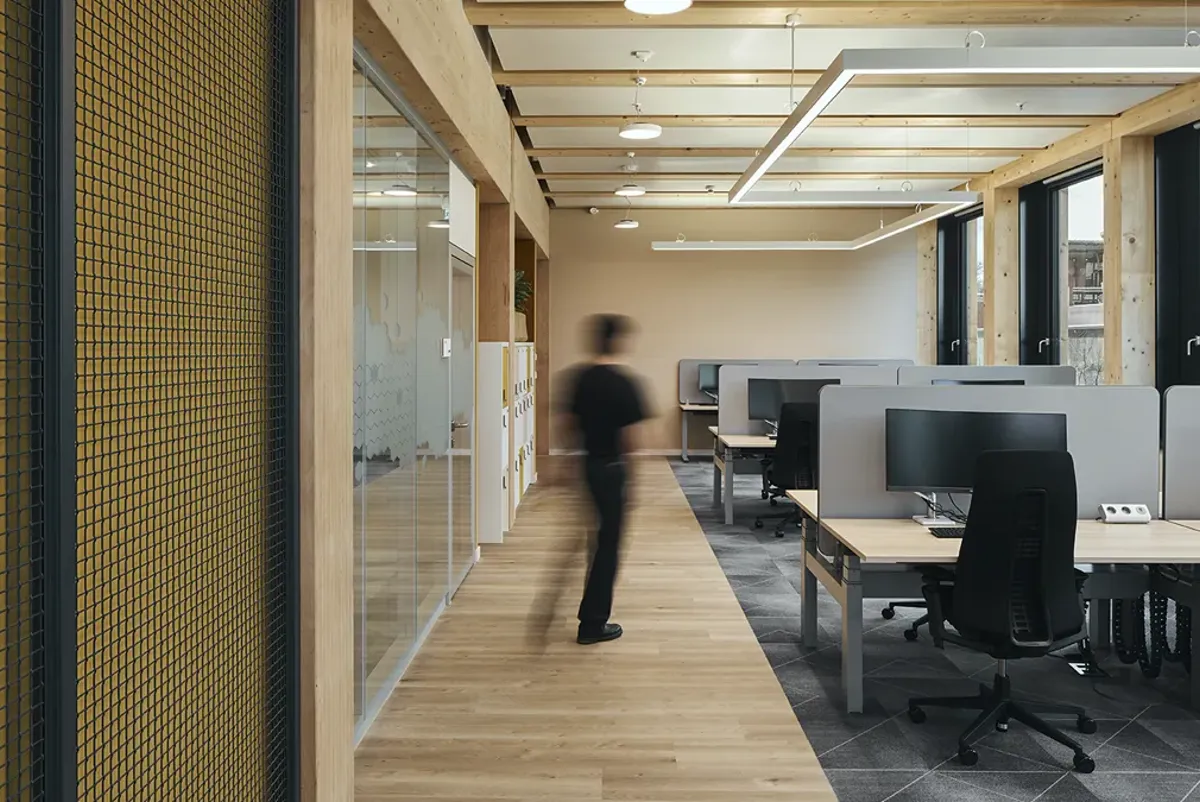 A person walking in an office.