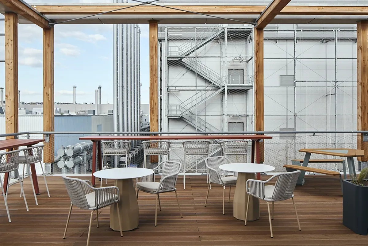 A group of tables and chairs on a deck.