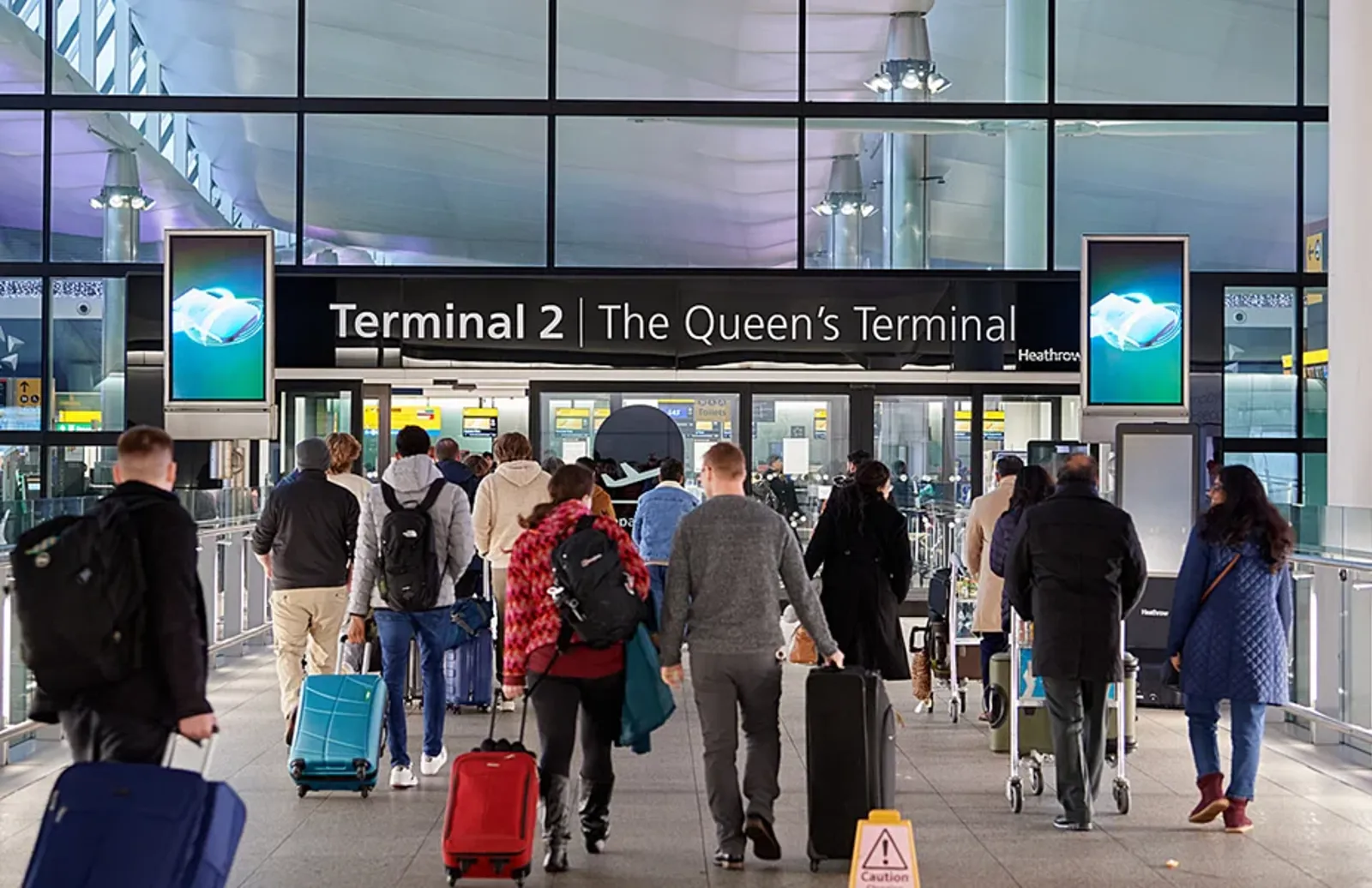 Passengers entering Heathrow's Terminal 2 building