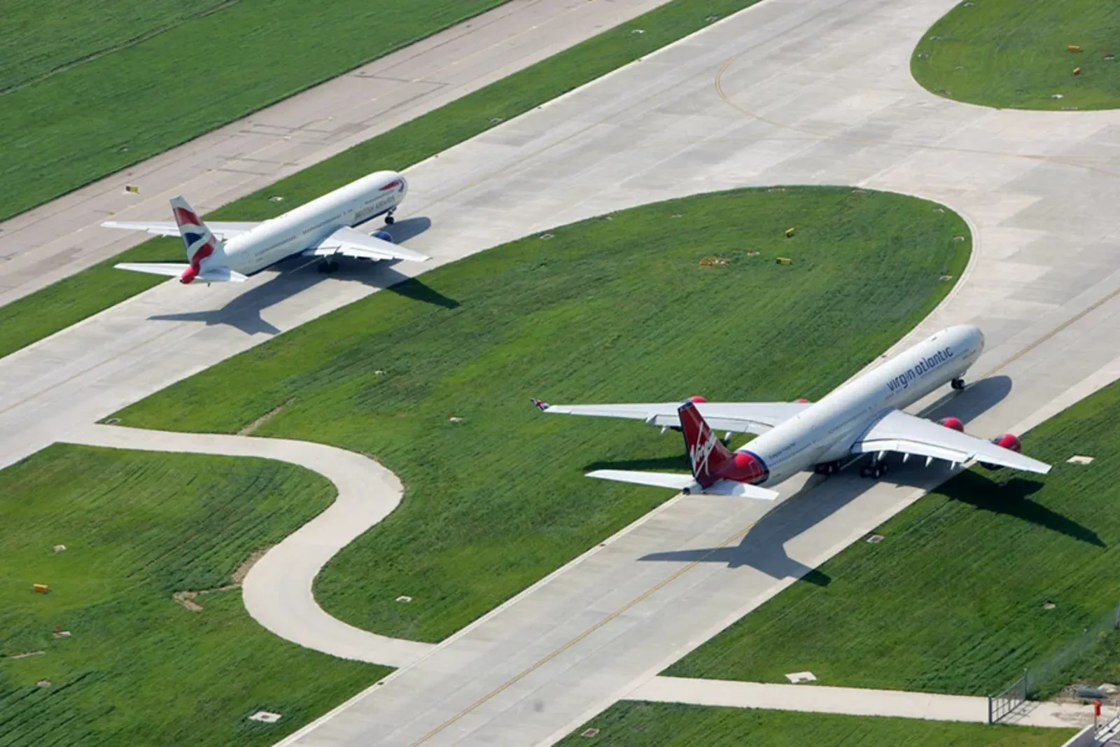 A group of airplanes flying over a field.