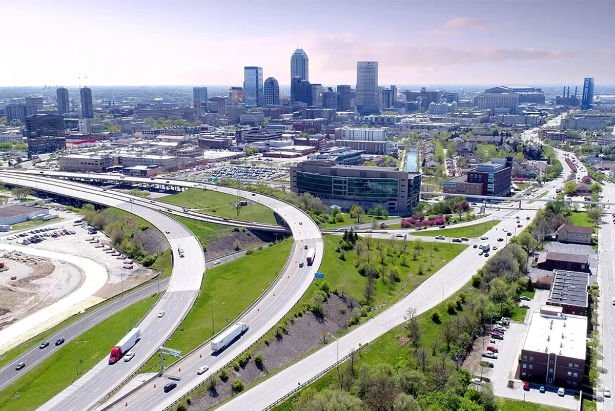 A freeway with cars and buildings in the distance