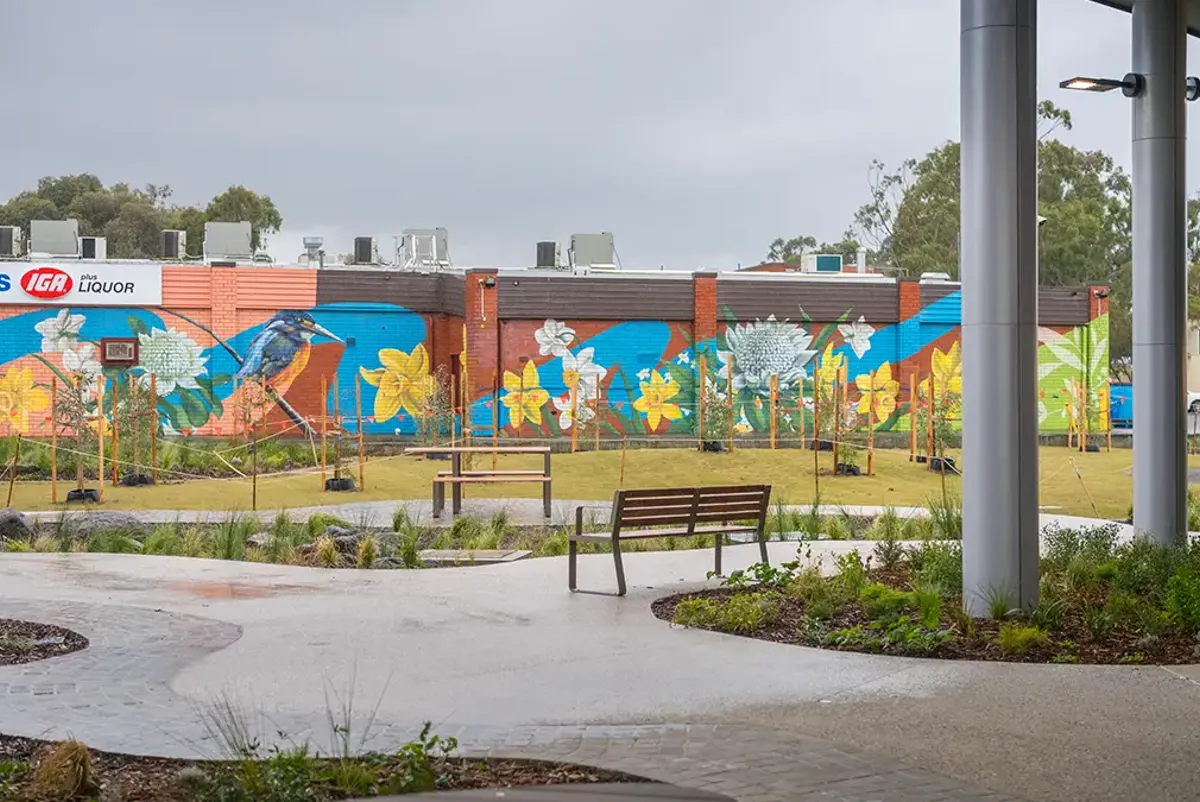 Walkway, seating and garden beds under road bridge