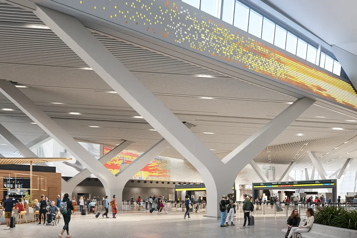 A group of people walking through airport terminal