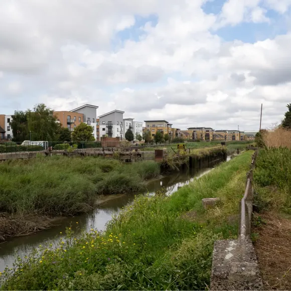 A river with a city in the background.