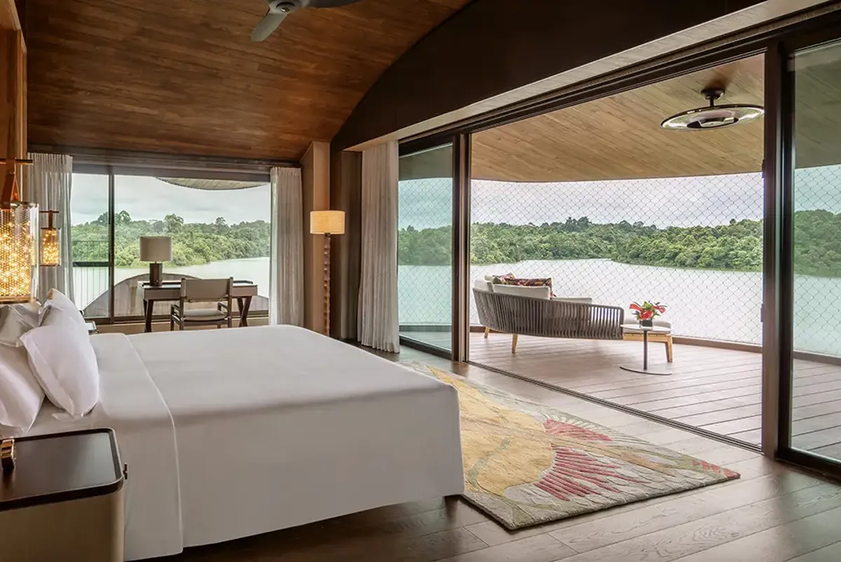 luxury hotel room with view over water and rainforest