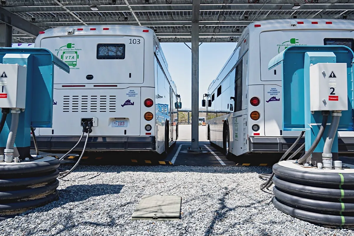 Electric buses plugged into chargers