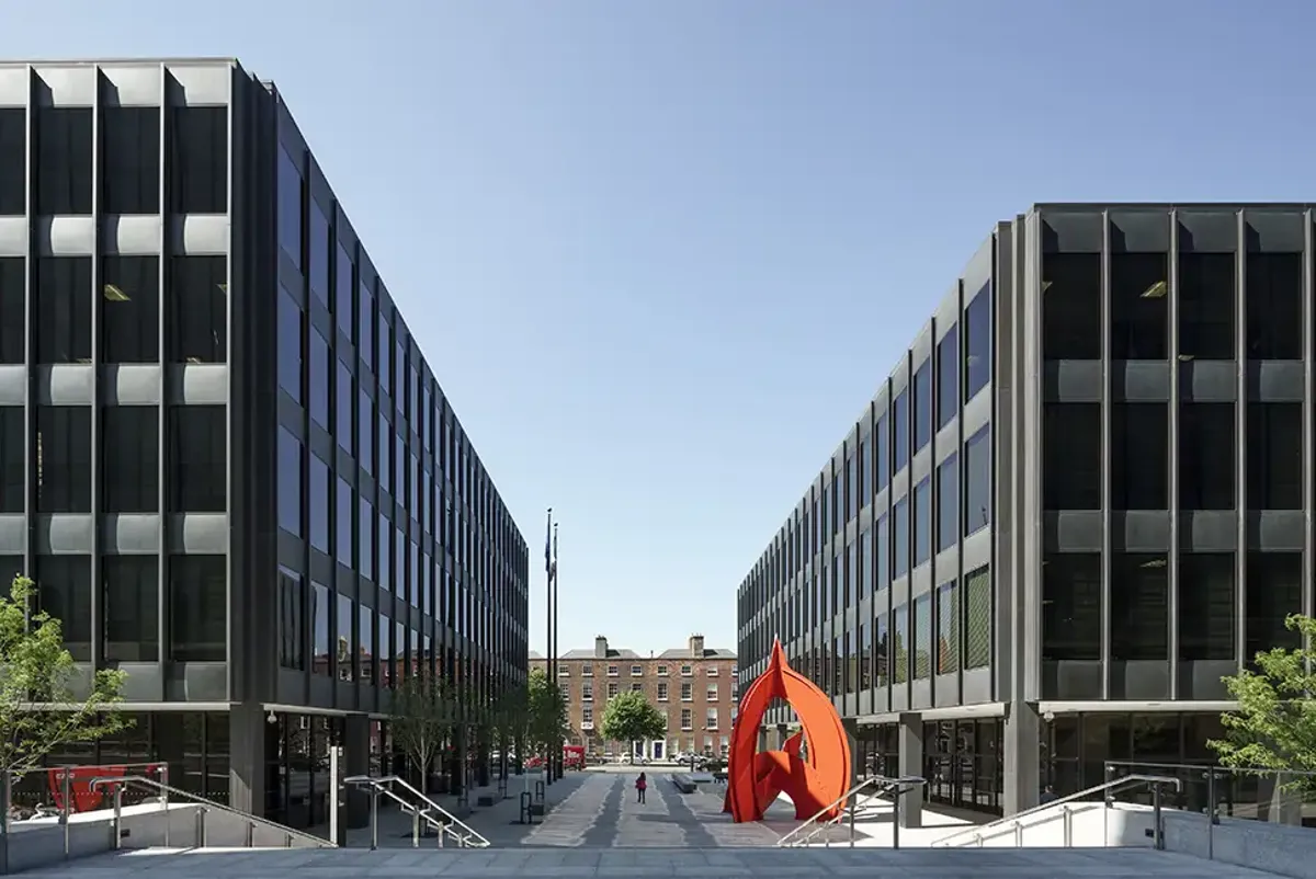 Exterior of Miesian Plaza buildings with sculpture in courtyard.
