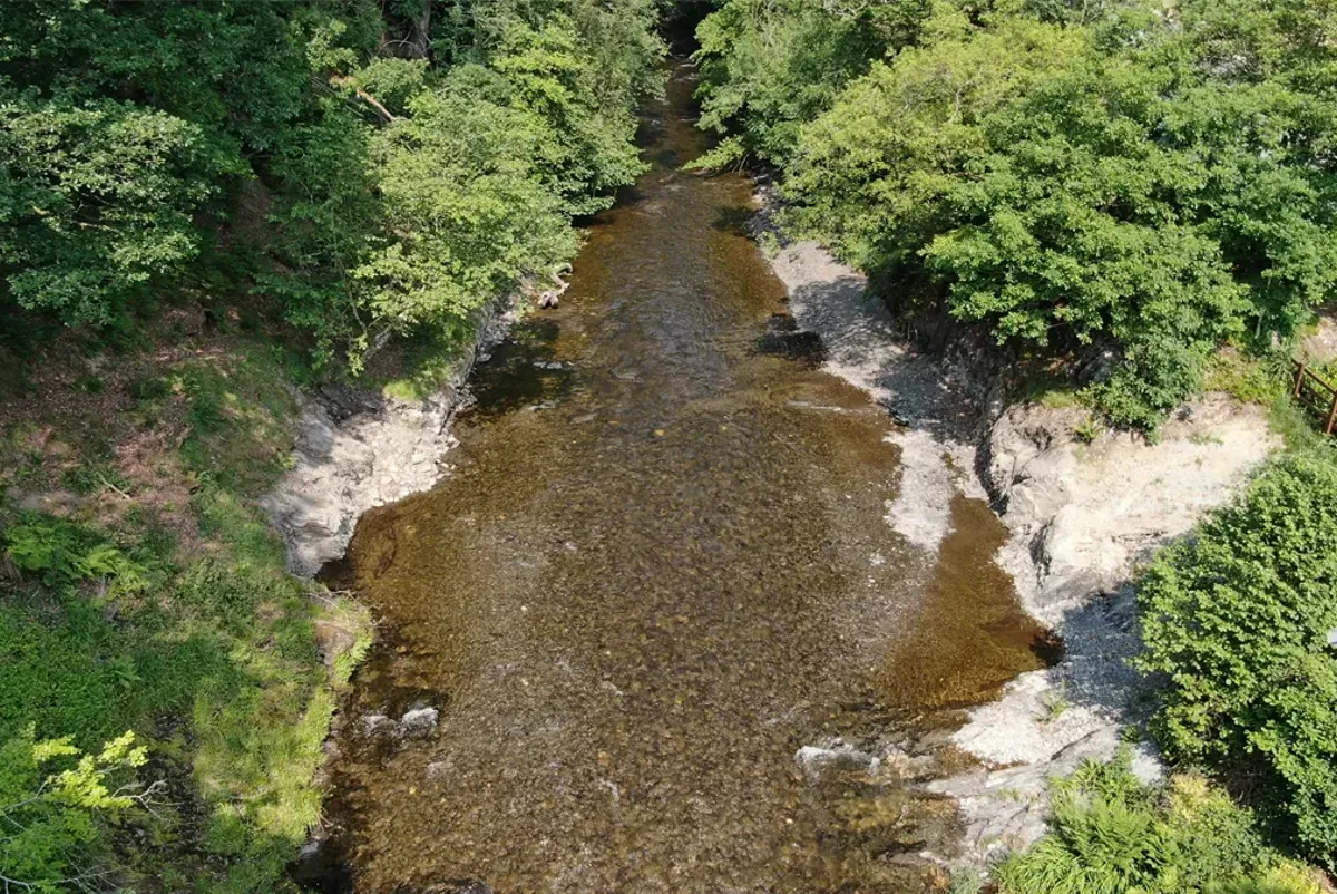A river with a small waterfall.