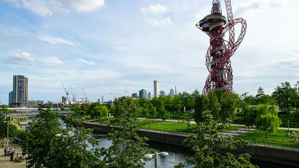 A ferris wheel by a river.