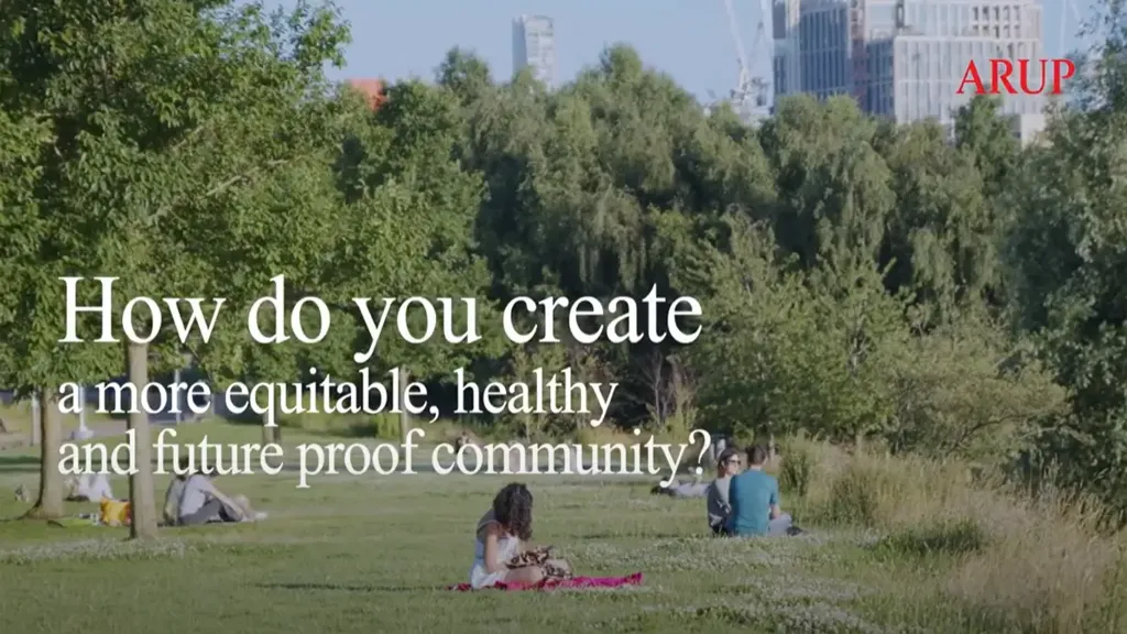A group of people sitting on the grass.