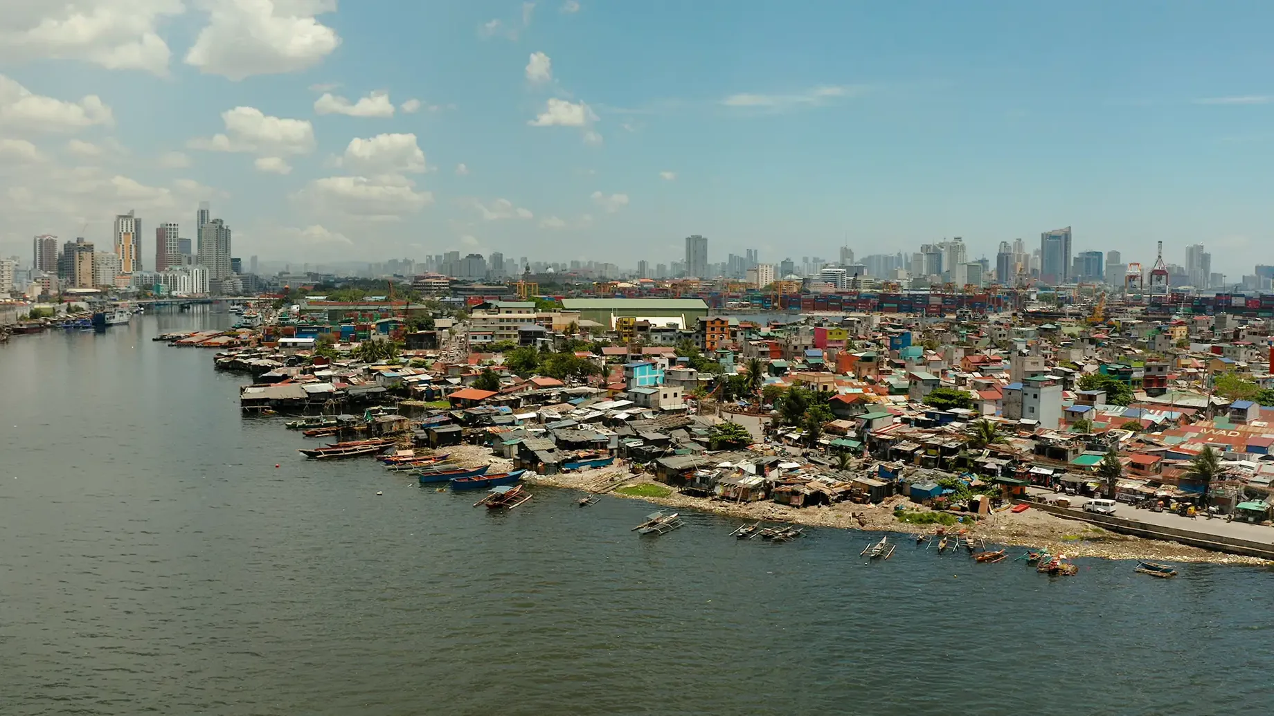 Manila’s city skyline in the distance with the Pasig River and buildings in the foreground