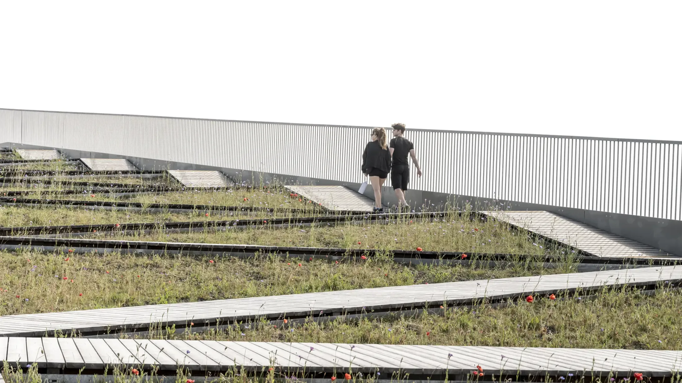 Two people walking across the Pilen viewing platform