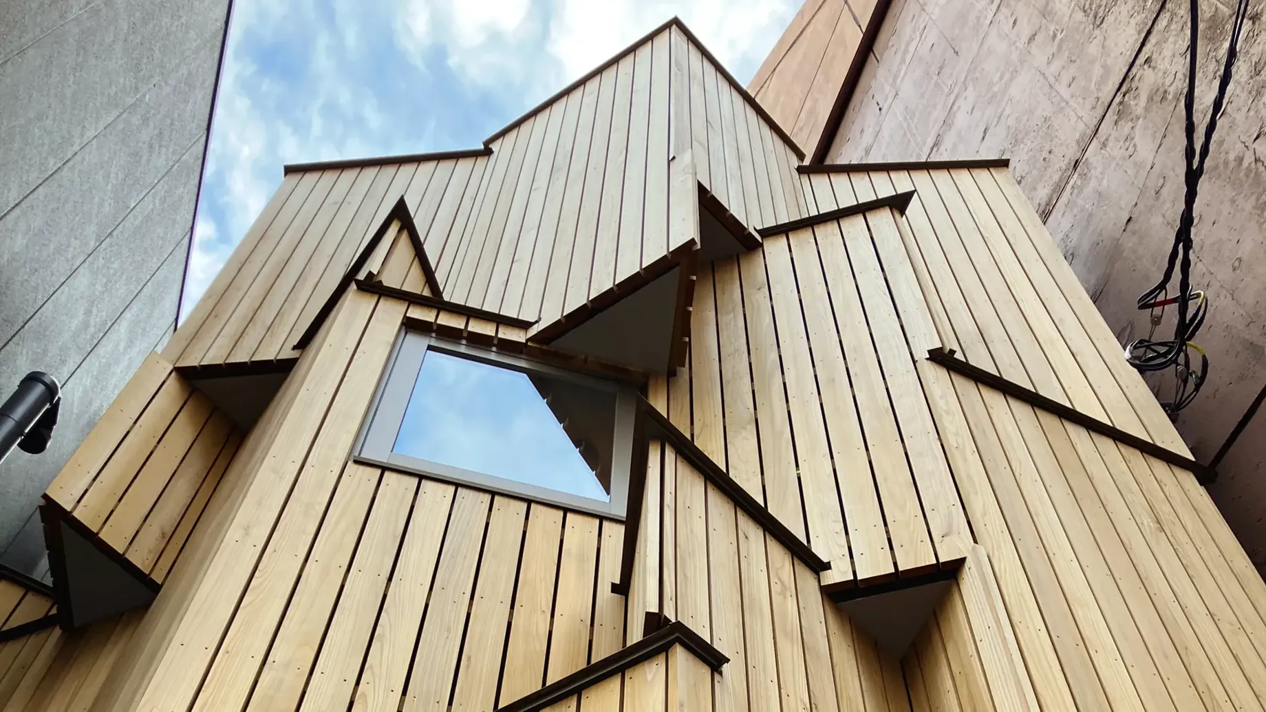 A demountable and relocatable timber building designed for compact urban sites.