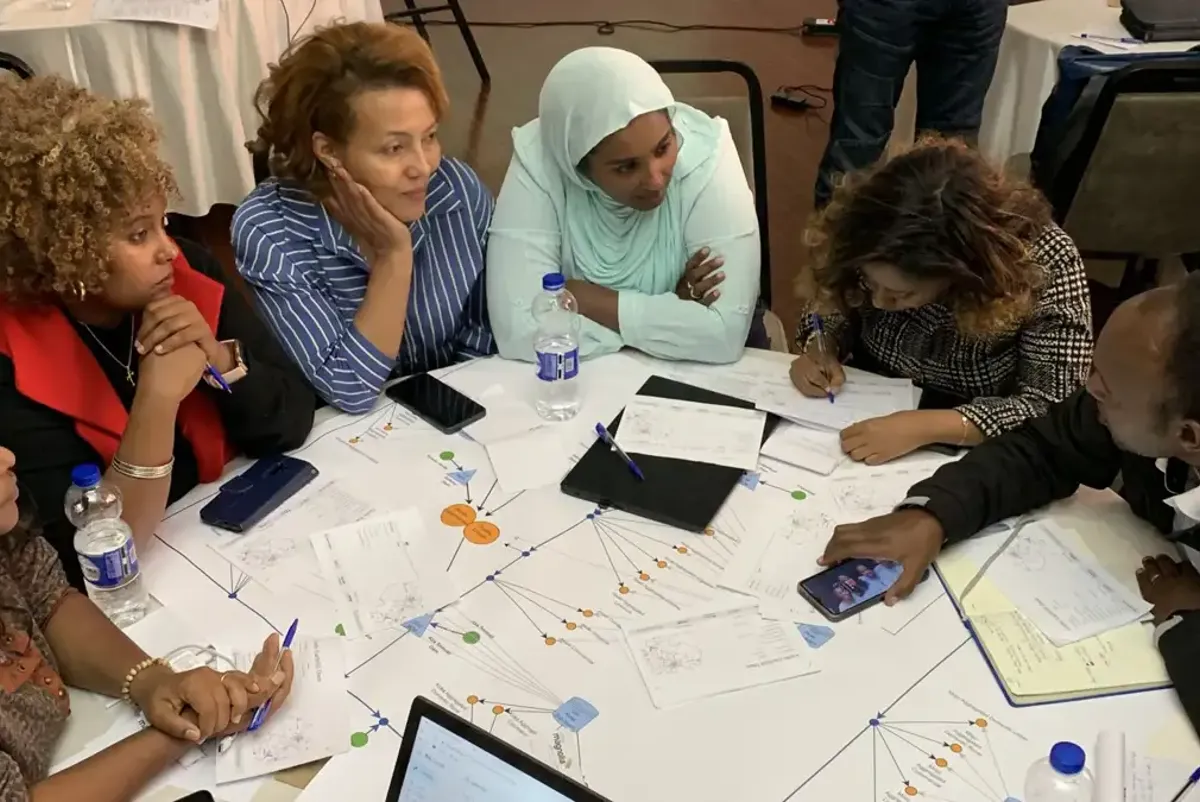 A group of people sitting around a table.