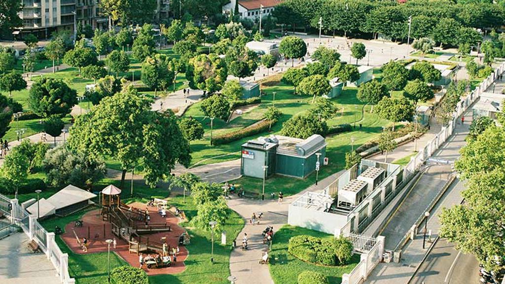 A park with trees and buildings.