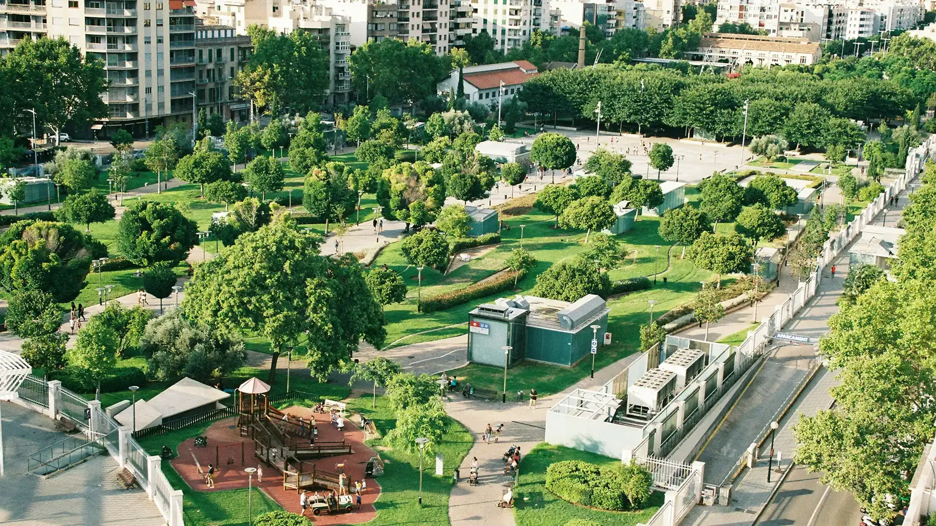 A park with trees and buildings.
