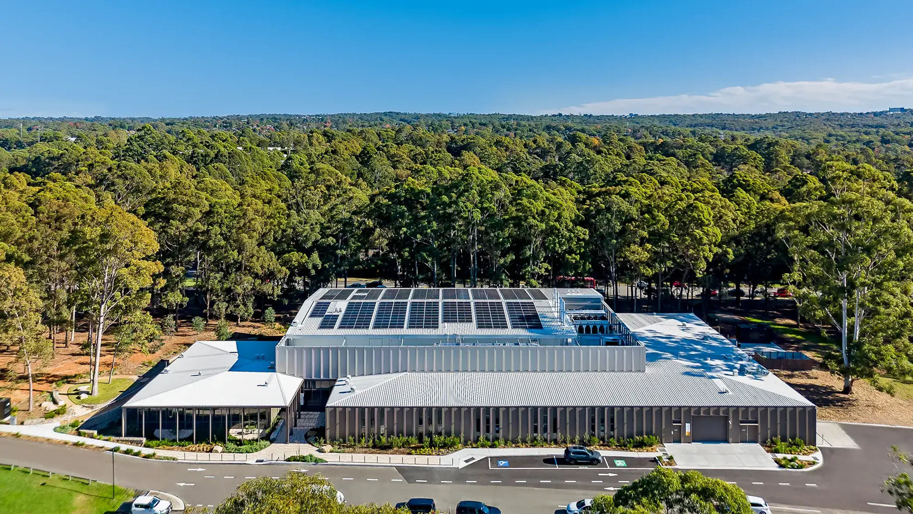 Ariel view of the RNA Research and Pilot Manufacturing Facility situated close by a large forest