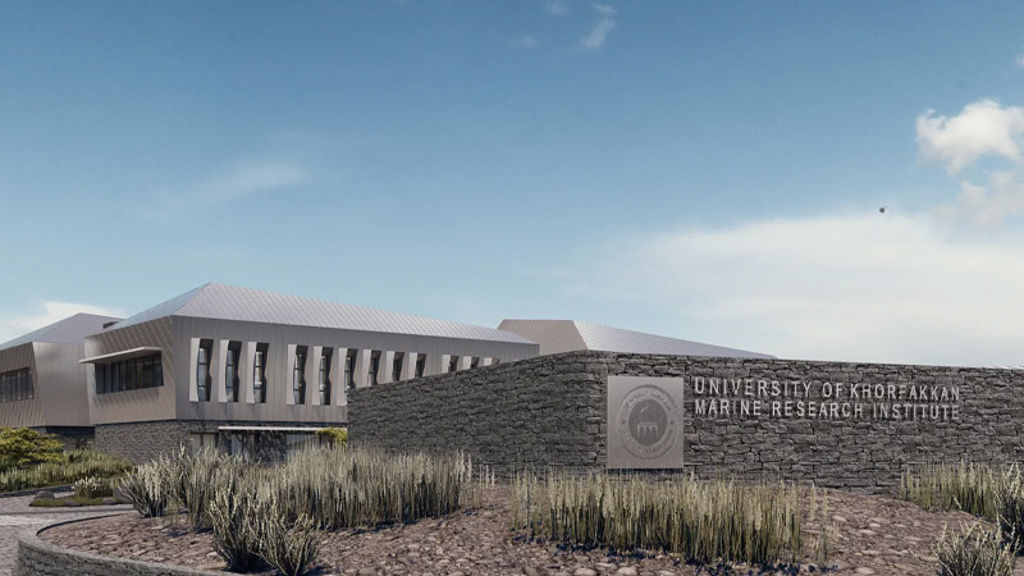 A building with a sign in front.