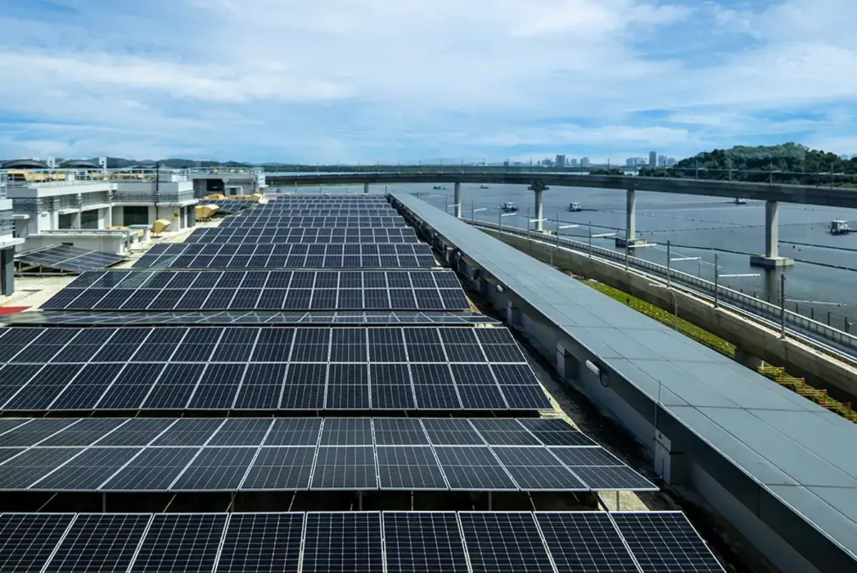 Rows of solar panels on roof of large building