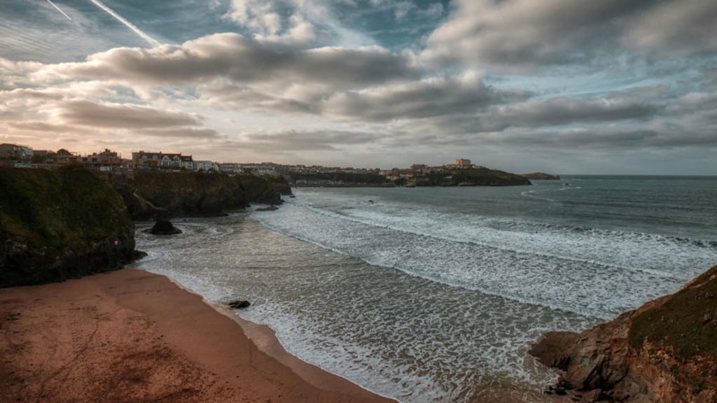 A beach with rocks and a body of water.