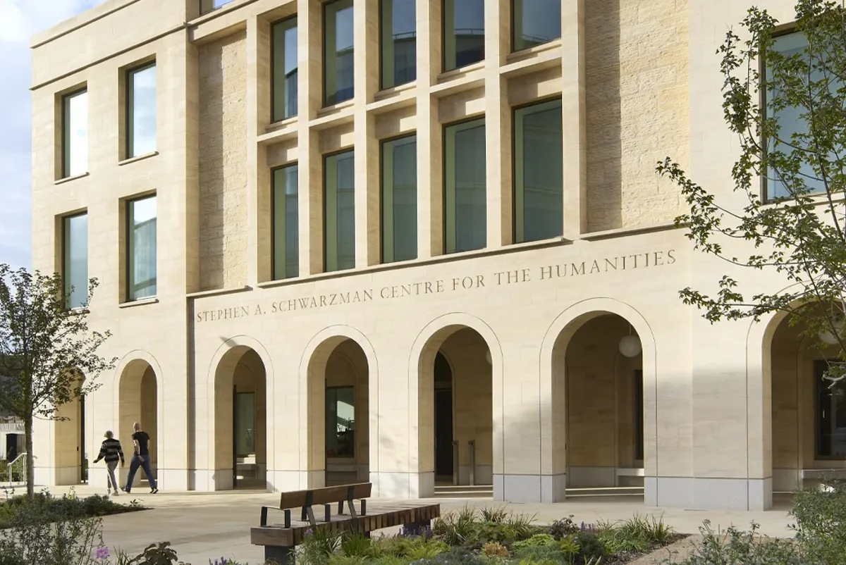 A building with a few people walking by it.