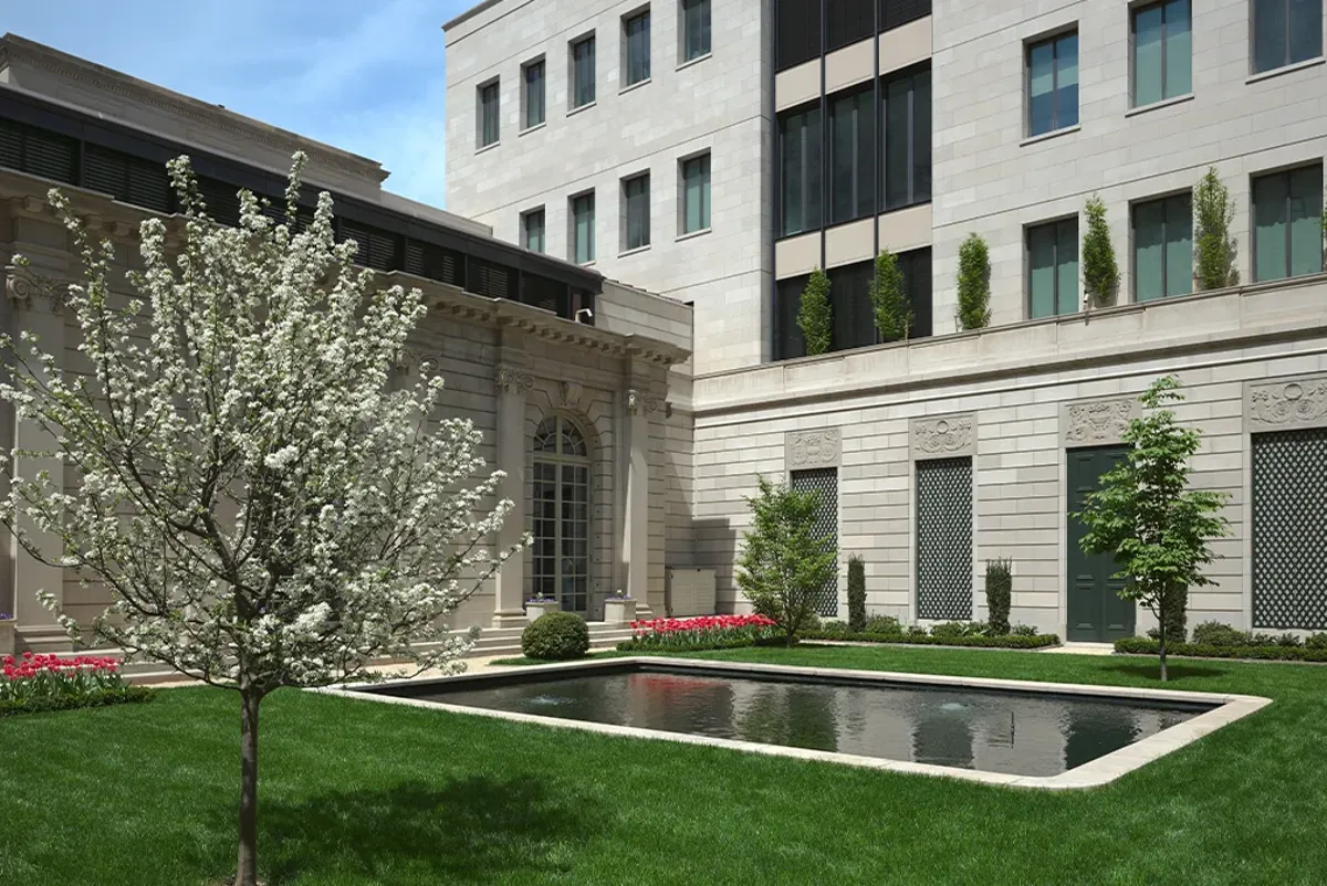 A building with a pond in front.