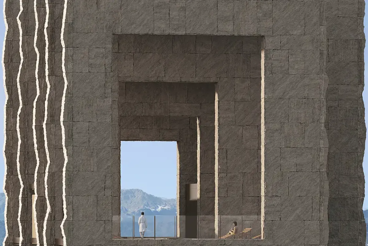 A person standing in a large stone archway.