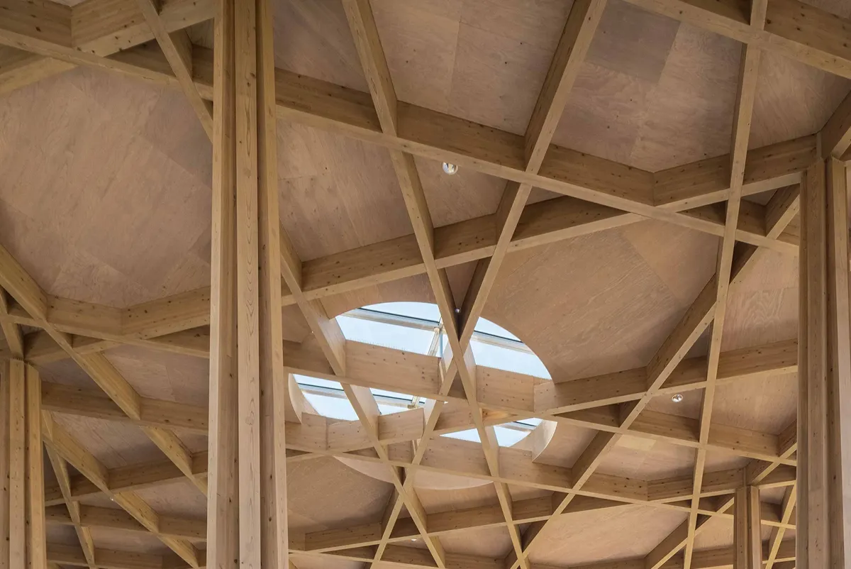 A wooden ceiling with a window.