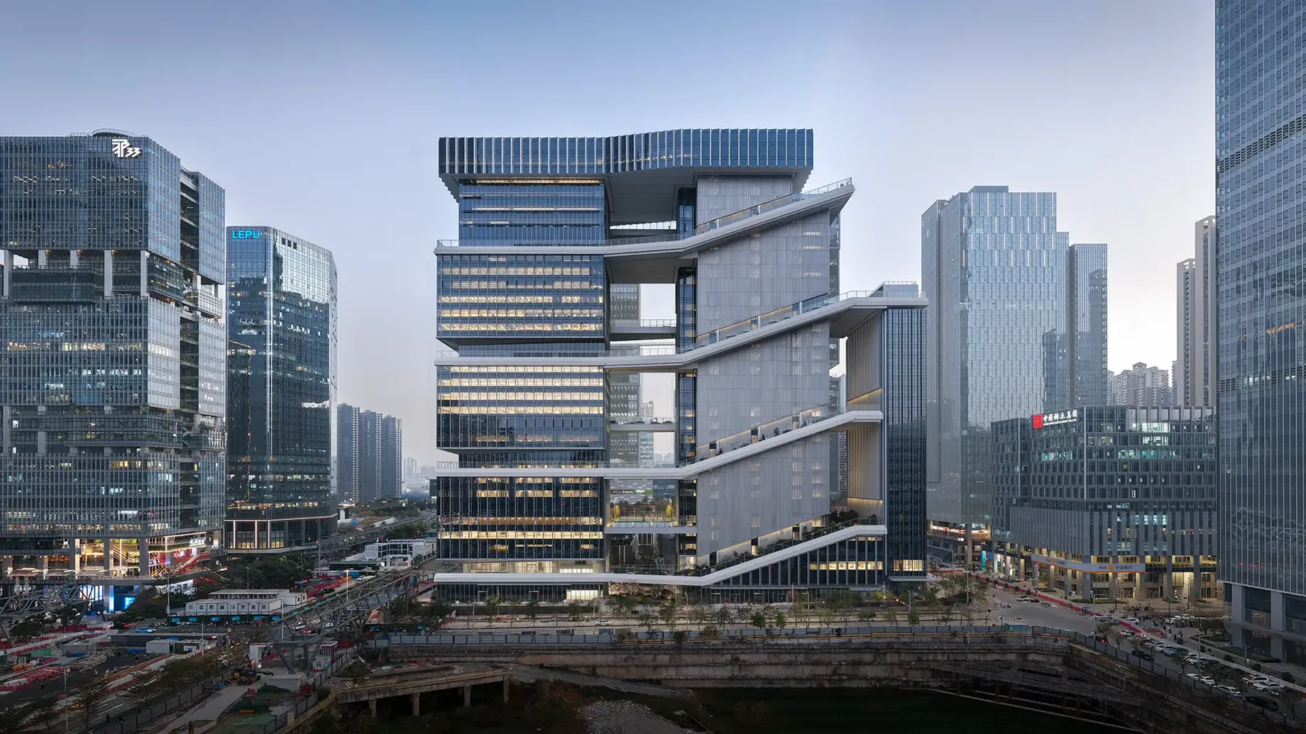 TP-LINK campus in Shenzhen features three buildings in a city block with cantilevered ribbon walkway that wraps around the entire campus.