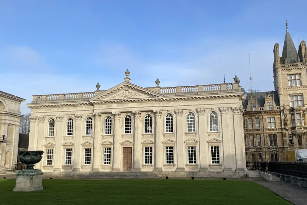A large building with a lawn in front of it.