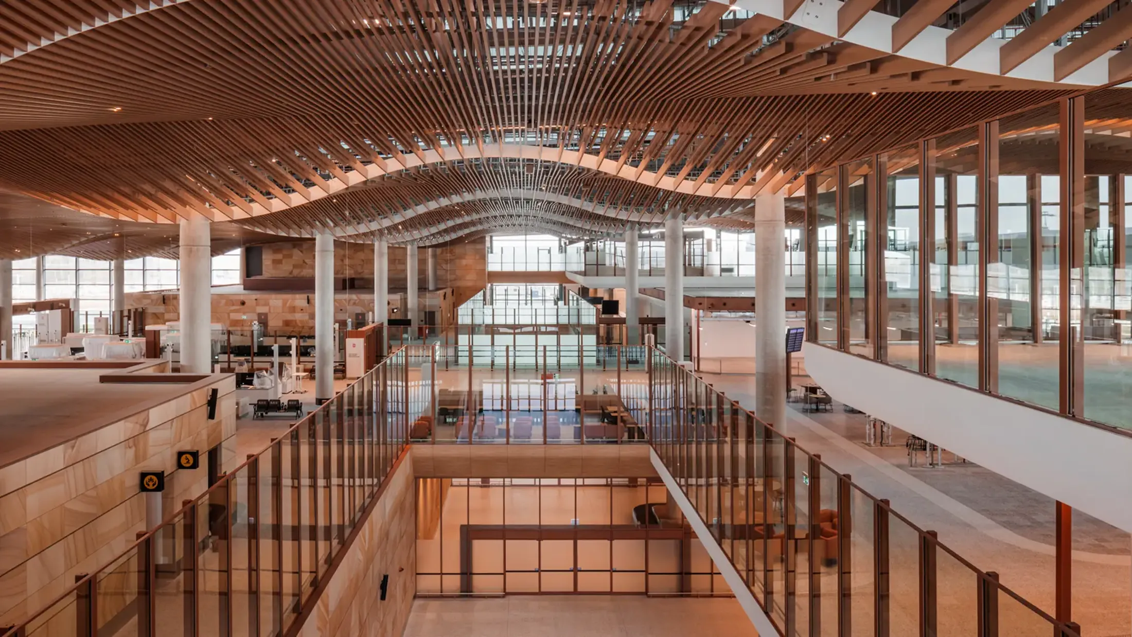 View of terminal ceiling with curved wood slats and lighting