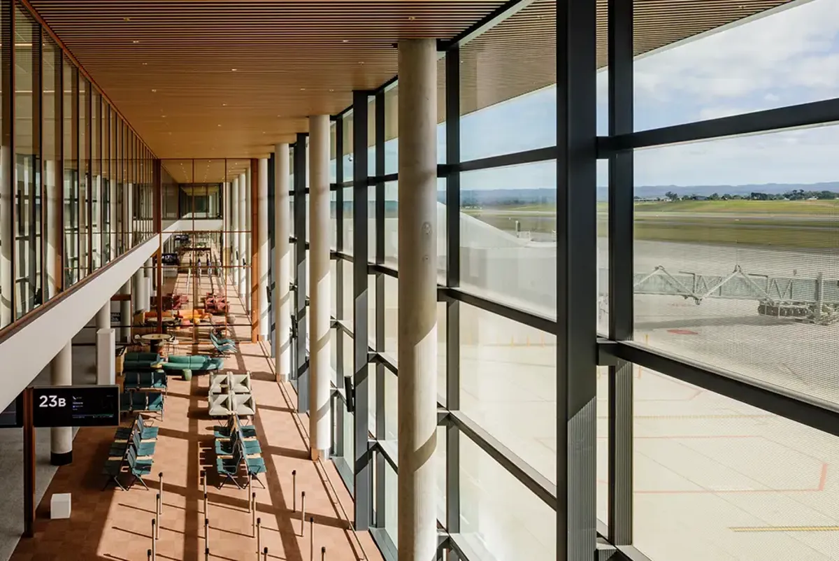 Gate lounges with two-storey high floor to ceiling windows.