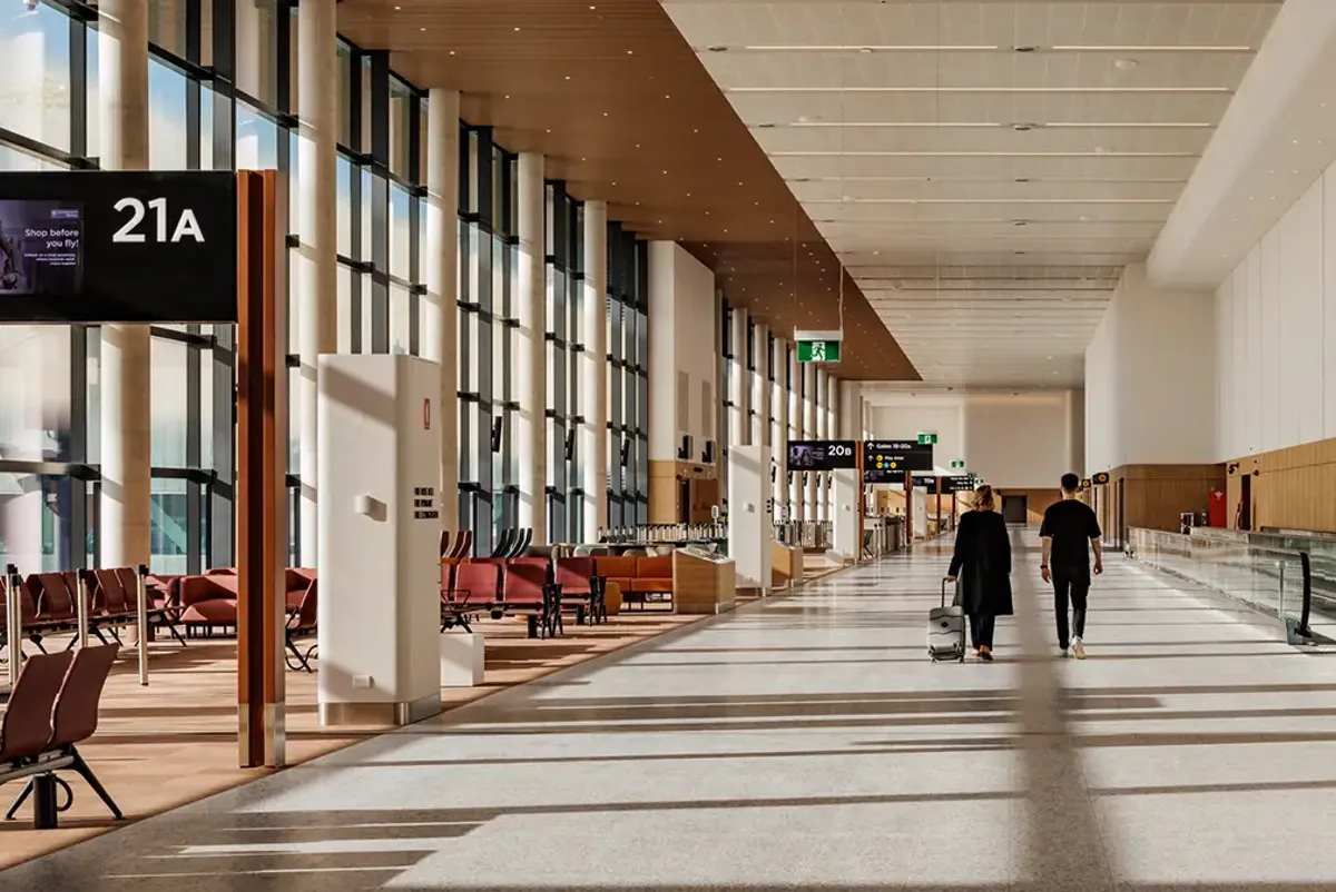 A couple walking past gate lounges inside Western Sydney International airport terminal
