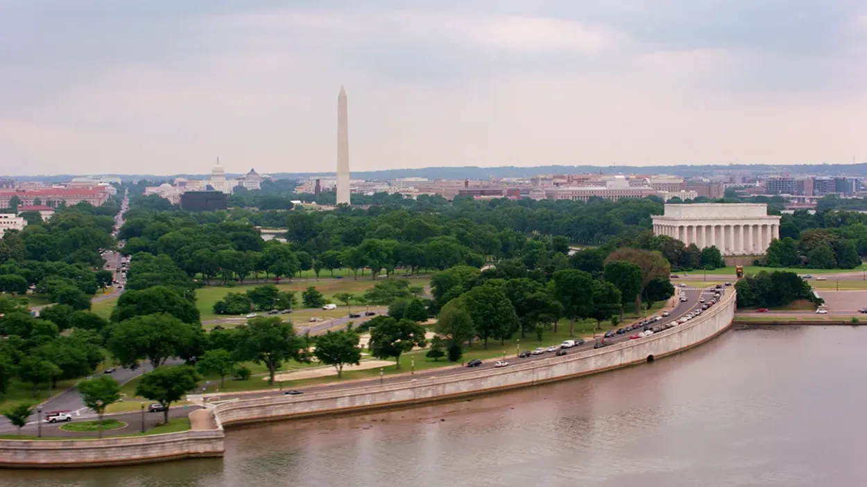 A river with a tall tower in the distance.