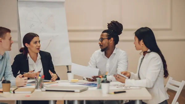 A group of people sitting around a table.