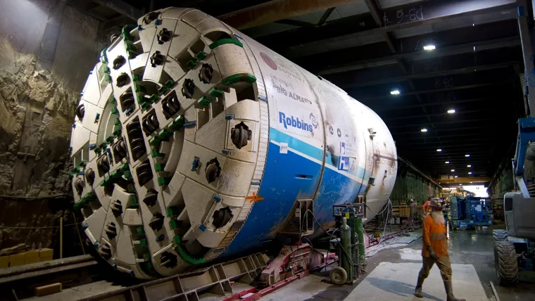 A person standing next to a large space shuttle.
